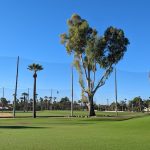 Panoramic view of a lush green golf course at Encanto 18. Smooth