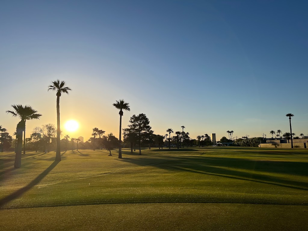 Panoramic view of a lush green golf course at Encanto 9-Hole Golf Course. Smooth