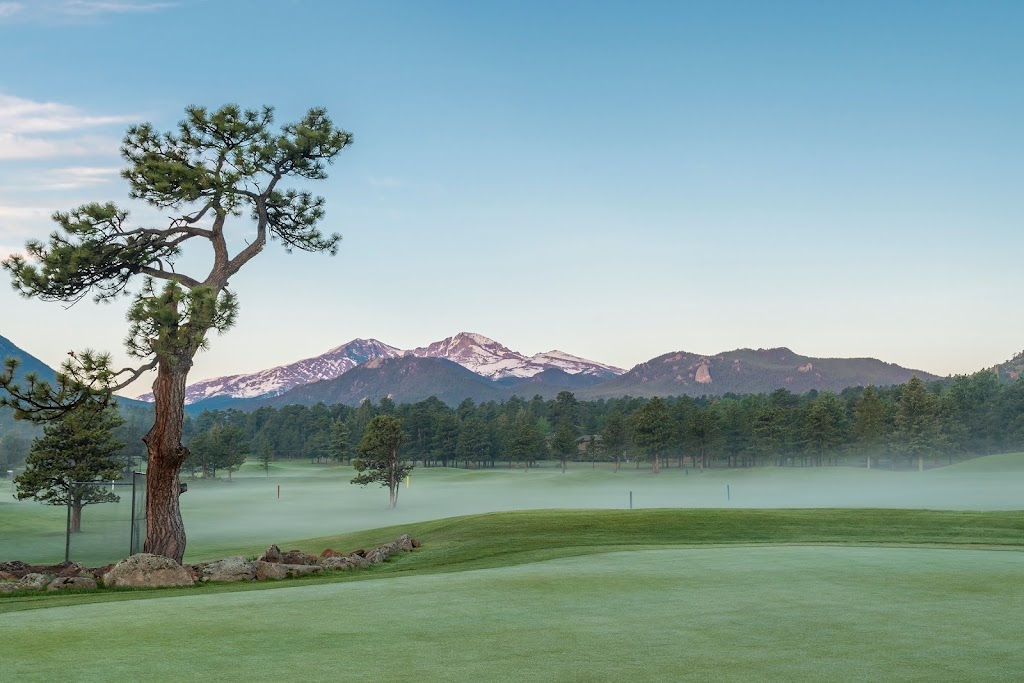 Panoramic view of a lush green golf course at Estes Park 18-Hole Golf Course. Smooth