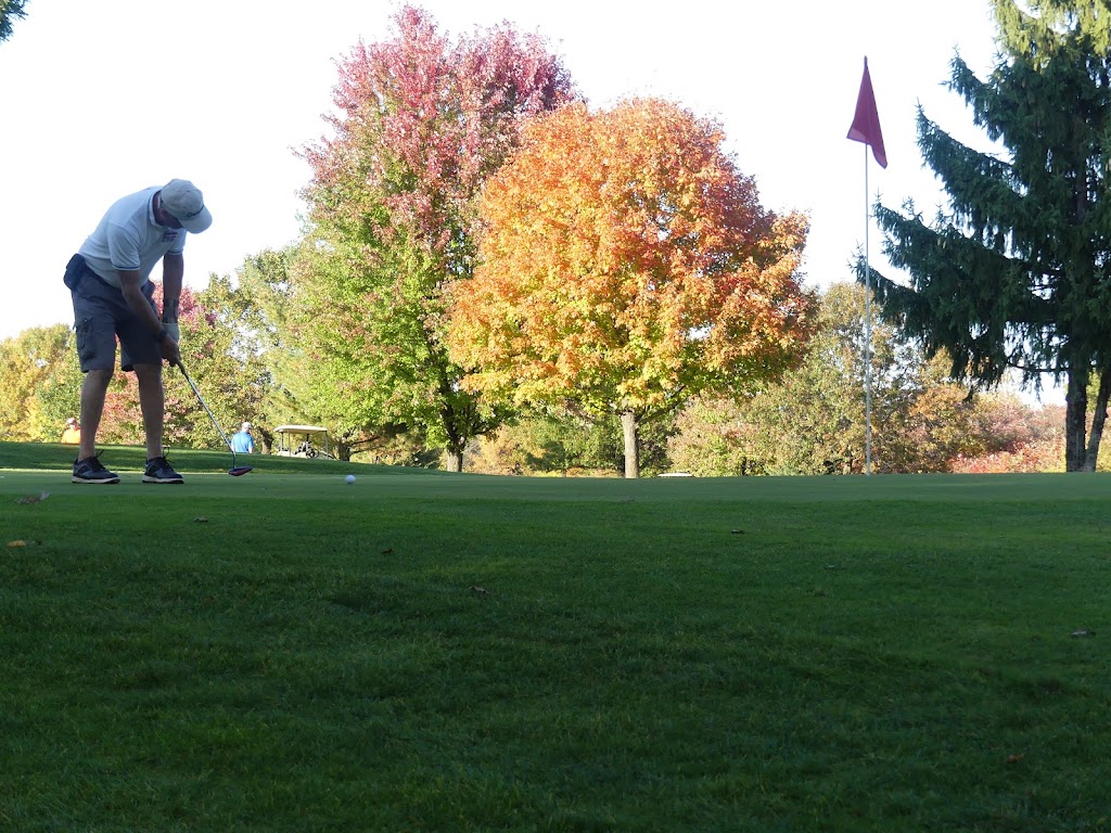 Panoramic view of a lush green golf course at Fairfield Hills Golf Course & Range. Smooth