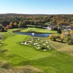 Panoramic view of a lush green golf course at Falmouth Country Club. Smooth