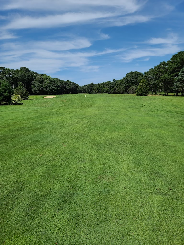 Panoramic view of a lush green golf course at Falmouth Country Club. Smooth