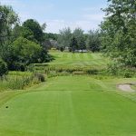 Panoramic view of a lush green golf course at Flushing Valley Golf Club. Smooth