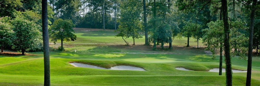 Panoramic view of a lush green golf course at Forest Hills Golf Course. Smooth