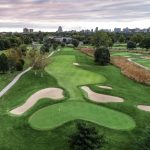 Panoramic view of a lush green golf course at Forest Park Golf Course. Smooth