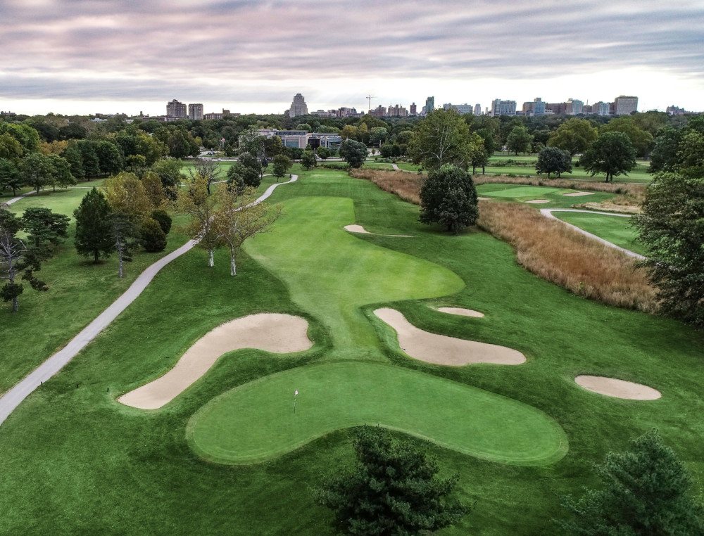 Panoramic view of a lush green golf course at Forest Park Golf Course. Smooth