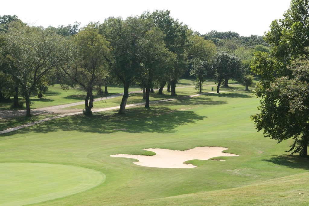 Panoramic view of a lush green golf course at Fort Sill Golf Course. Smooth