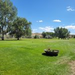 Panoramic view of a lush green golf course at Foster Gulch Golf Course. Smooth