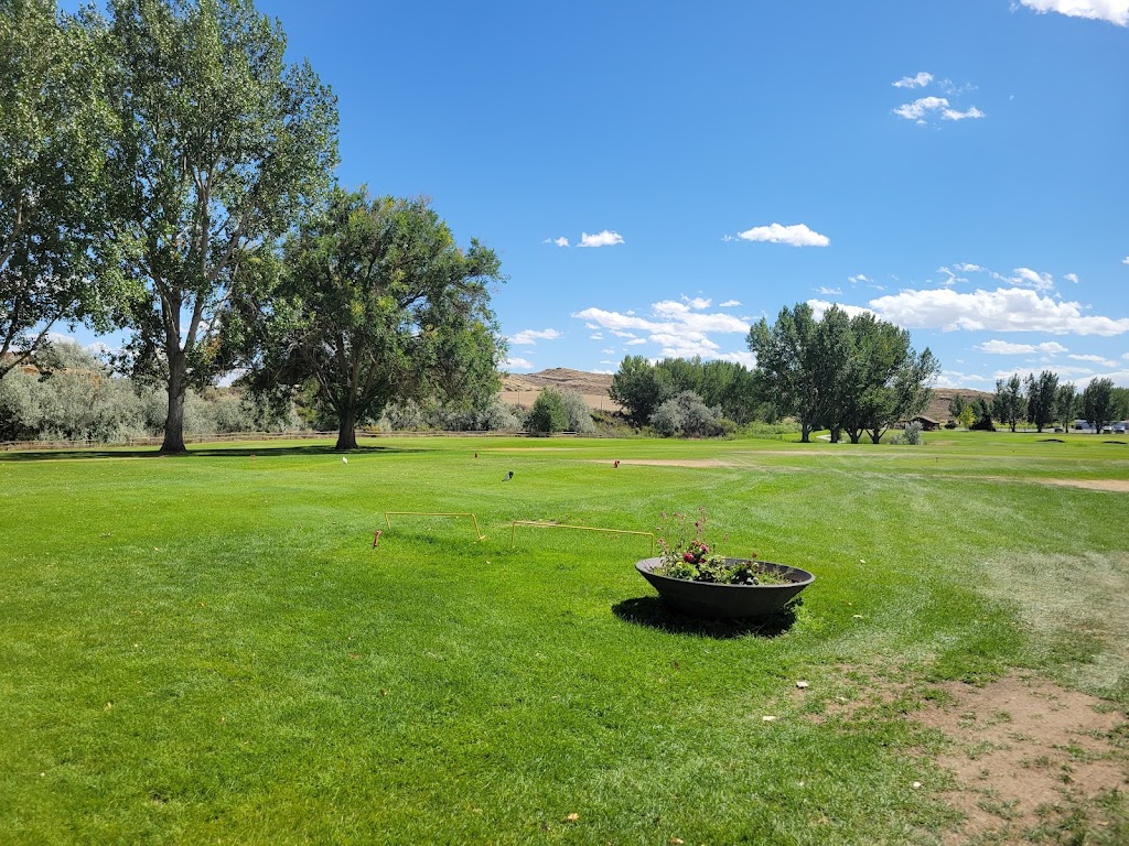 Panoramic view of a lush green golf course at Foster Gulch Golf Course. Smooth