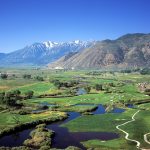 Panoramic view of a lush green golf course at Genoa Lakes Golf Club - Lakes Course and Ranch Course. Smooth