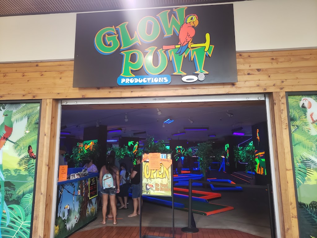 Panoramic view of a lush green golf course at Glow Putt Mini Golf. Smooth