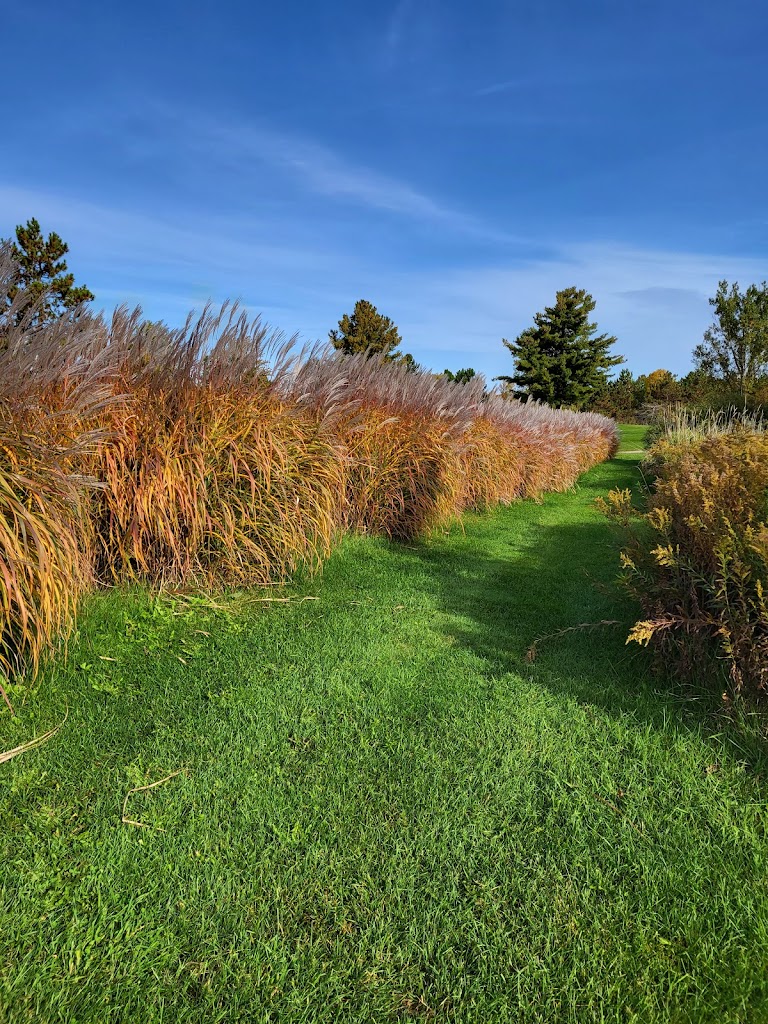 Panoramic view of a lush green golf course at Golden Sands Golf Club. Smooth