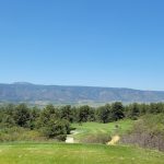 Panoramic view of a lush green golf course at Golf Club At Bear Dance. Smooth