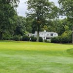 Panoramic view of a lush green golf course at Golf Club of Avon. Smooth