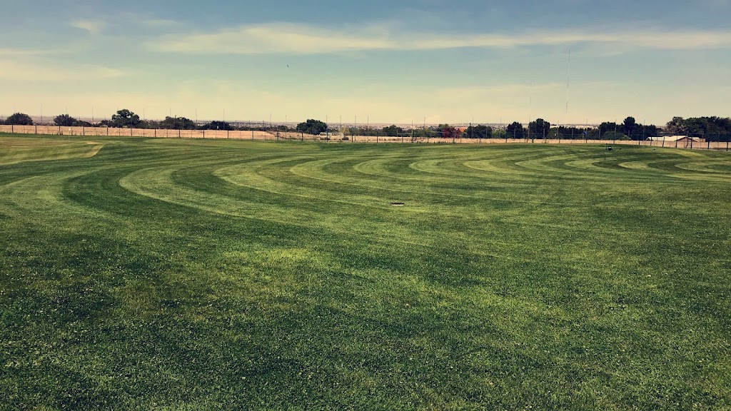 Panoramic view of a lush green golf course at Golf & Event Center at Balloon Fiesta Park. Smooth