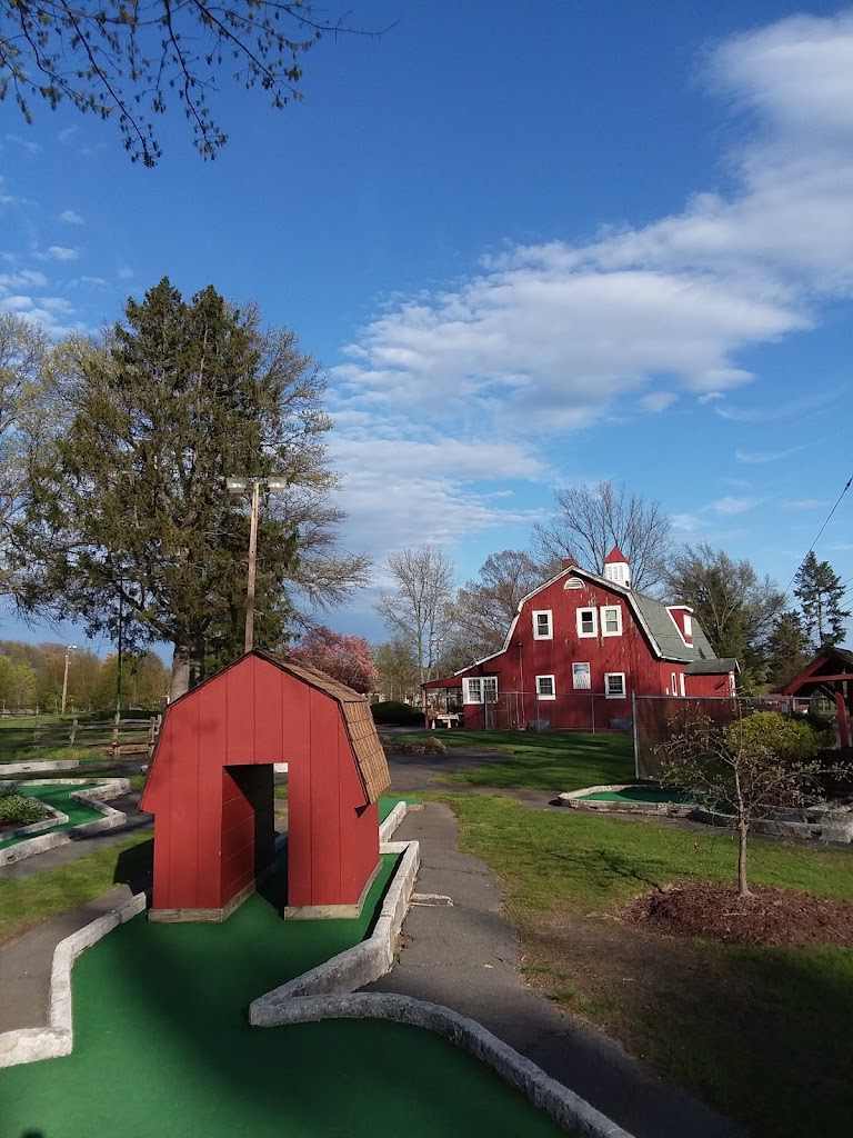 Panoramic view of a lush green golf course at GolfLand. Smooth