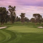 Panoramic view of a lush green golf course at Grand Canyon University Championship Golf Course. Smooth