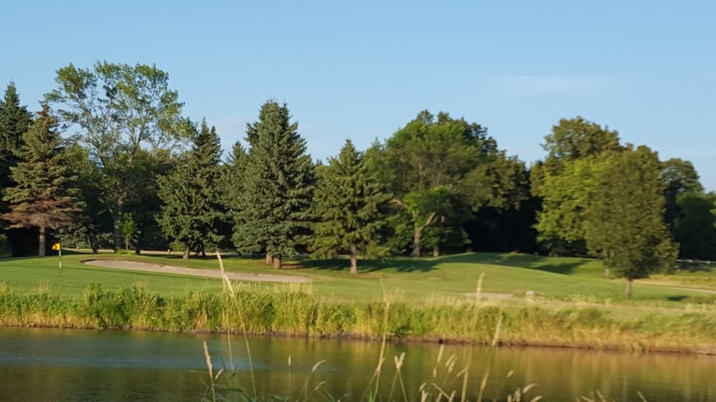 Panoramic view of a lush green golf course at Grand Forks Country Club. Smooth