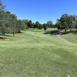 Panoramic view of a lush green golf course at Grandview Golf Course. Smooth