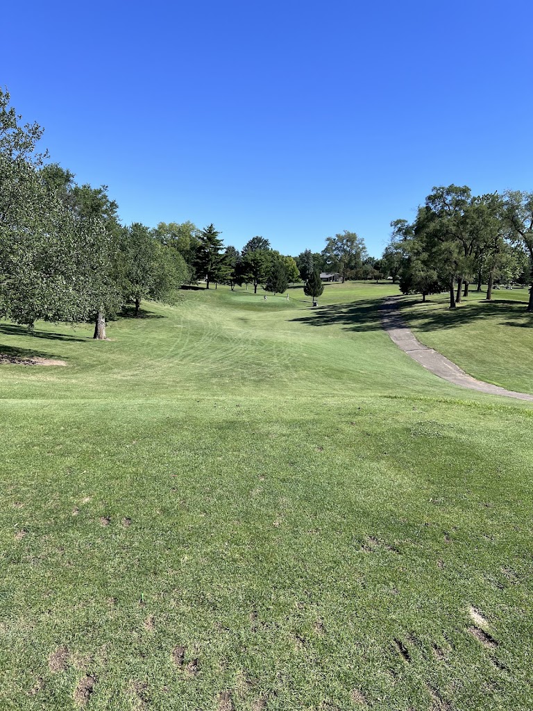 Panoramic view of a lush green golf course at Grandview Golf Course. Smooth