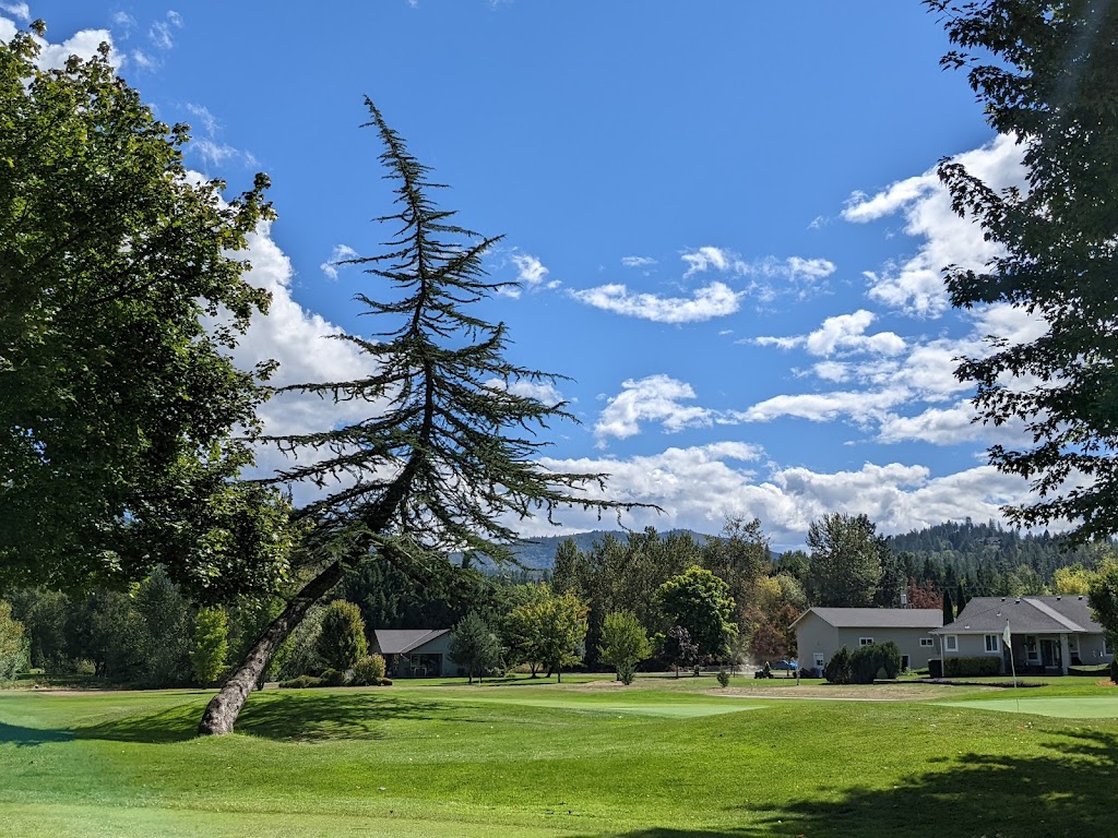 Panoramic view of a lush green golf course at Grants Pass Golf Club. Smooth