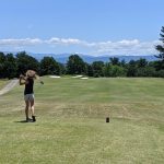 green grass with the flag in the hole.