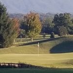 Panoramic view of a lush green golf course at Green Meadow Country Club. Smooth