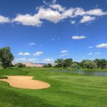 Panoramic view of a lush green golf course at Green River Golf Course. Smooth