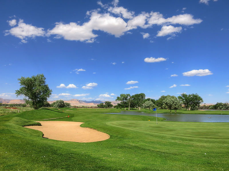 Panoramic view of a lush green golf course at Green River Golf Course. Smooth