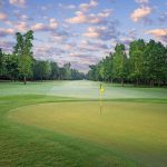 Panoramic view of a lush green golf course at Greystone Golf & Country Club. Smooth