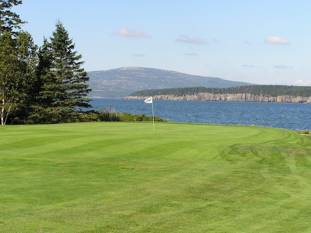 Panoramic view of a lush green golf course at Grindstone Neck Golf Course. Smooth