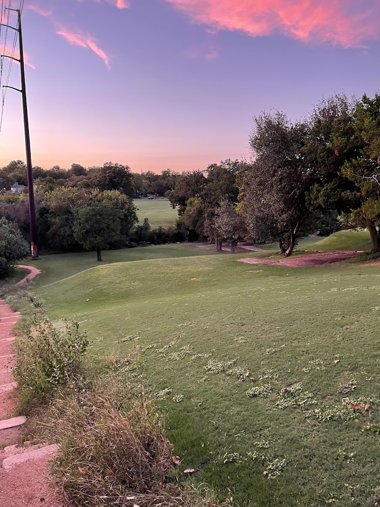 Panoramic view of a lush green golf course at Hancock Golf Course. Smooth