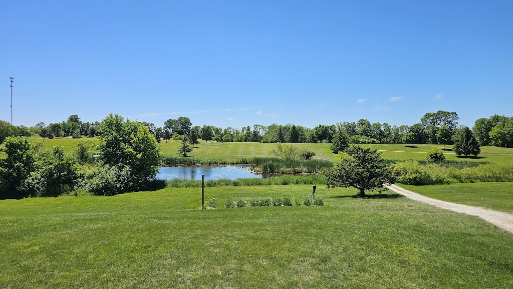 Panoramic view of a lush green golf course at Hardwood Hills Golf Course. Smooth