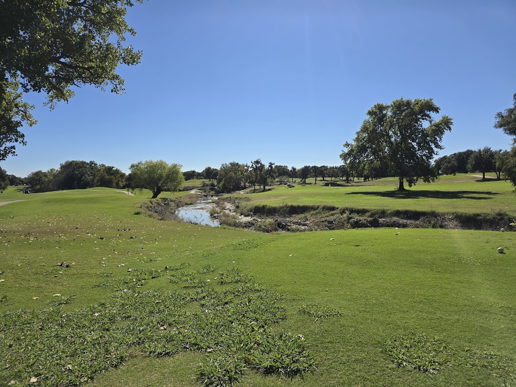 Panoramic view of a lush green golf course at Hawks Creek Golf Club. Smooth