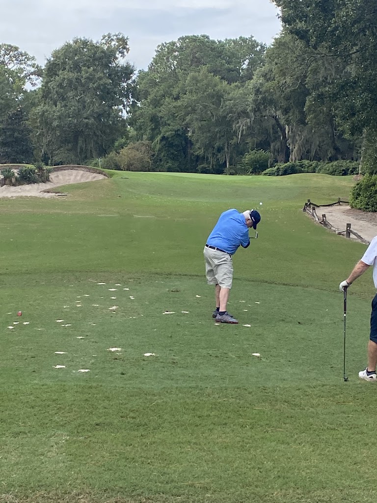 Panoramic view of a lush green golf course at Heritage Club. Smooth