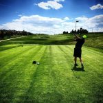 green grass with the flag in the hole.