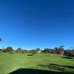 Panoramic view of a lush green golf course at Heroes Golf Course. Smooth