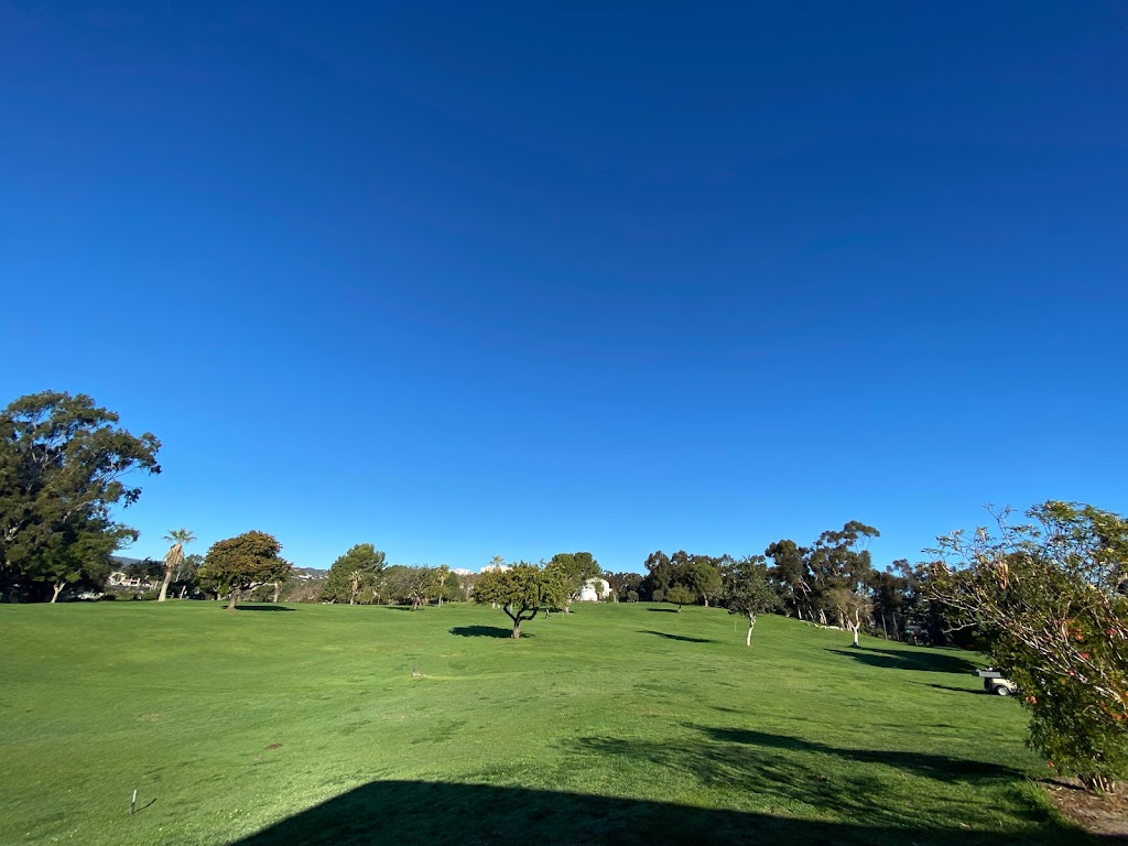 Panoramic view of a lush green golf course at Heroes Golf Course. Smooth