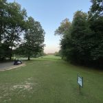 Panoramic view of a lush green golf course at Hickory Creek Golf Course. Smooth