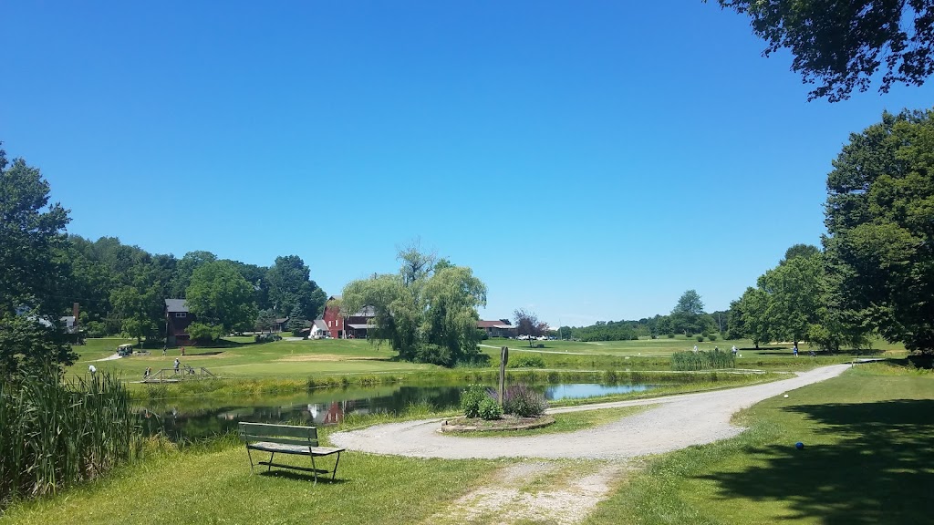 Panoramic view of a lush green golf course at Hidden Acres Golf Course. Smooth