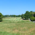 Panoramic view of a lush green golf course at Hidden Creek Golf Club. Smooth