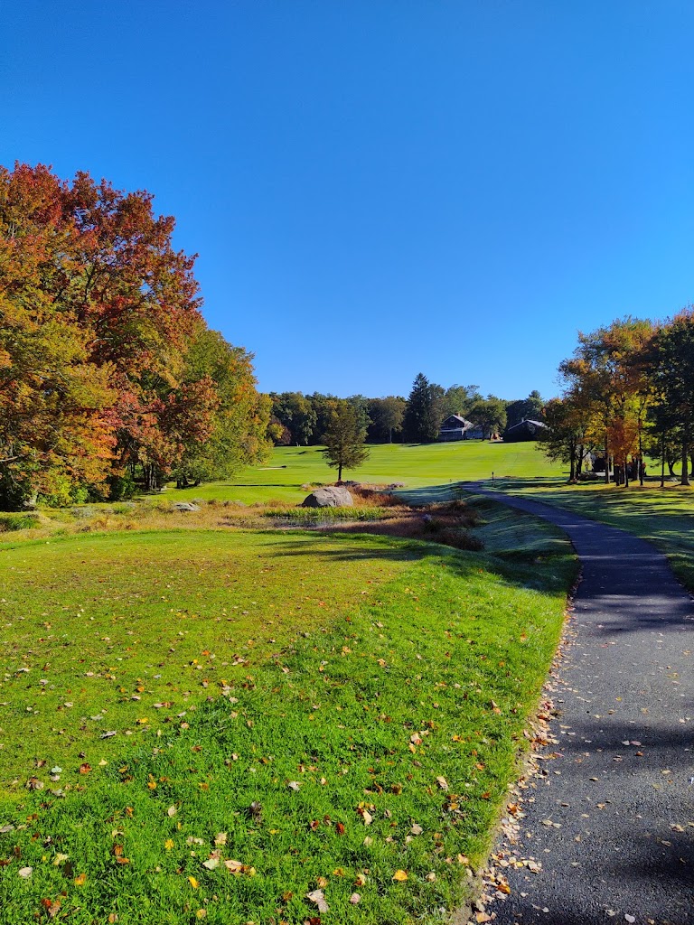 Panoramic view of a lush green golf course at Hidden Hollow Country Club. Smooth