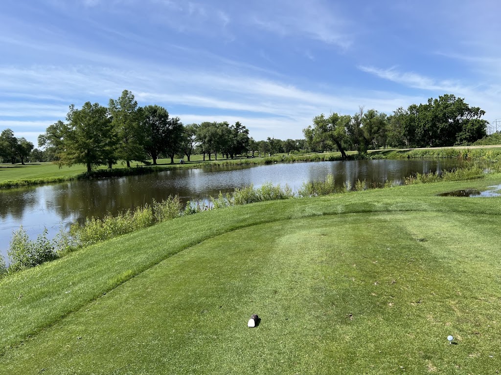 Panoramic view of a lush green golf course at Hidden Lakes Golf Course. Smooth