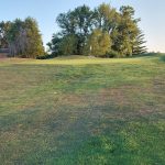 Panoramic view of a lush green golf course at Hidden Valley Golf Course. Smooth