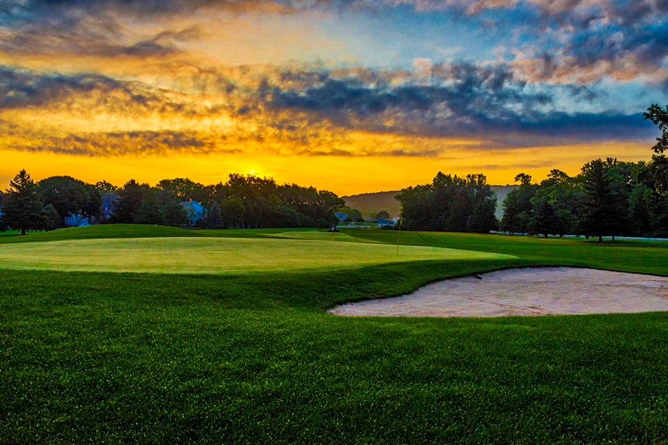 Panoramic view of a lush green golf course at High Cliff Golf and Event Center. Smooth