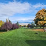 Panoramic view of a lush green golf course at Highlands Golf Club. Smooth