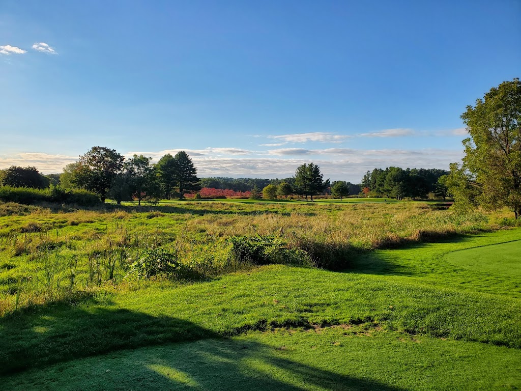 Panoramic view of a lush green golf course at Hoodkroft Country Club. Smooth