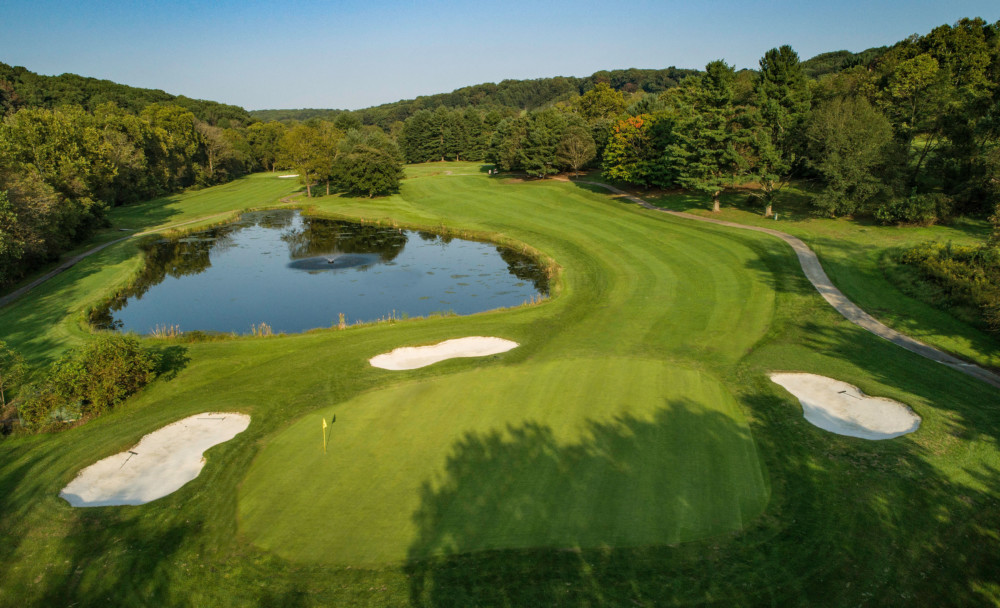 Panoramic view of a lush green golf course at Hunt Valley Country Club. Smooth