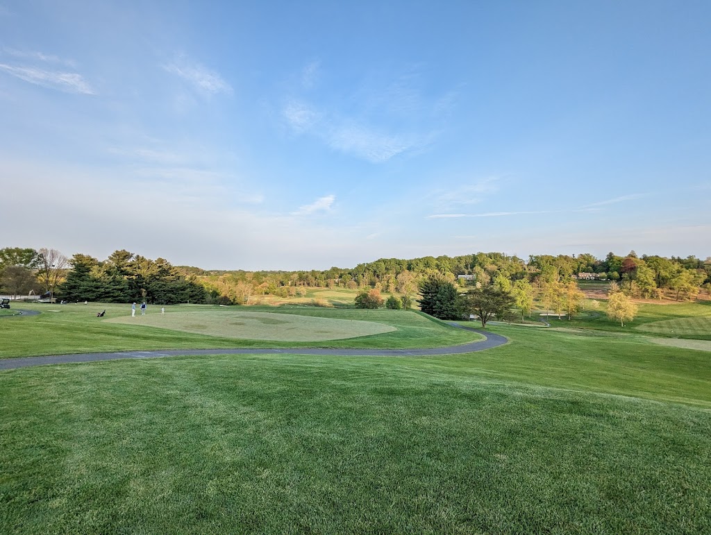 Panoramic view of a lush green golf course at Huntingdon Valley Country Club. Smooth