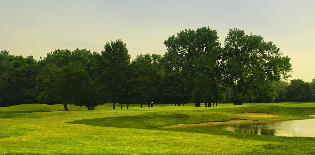 Panoramic view of a lush green golf course at Indian Boundary Golf Course. Smooth